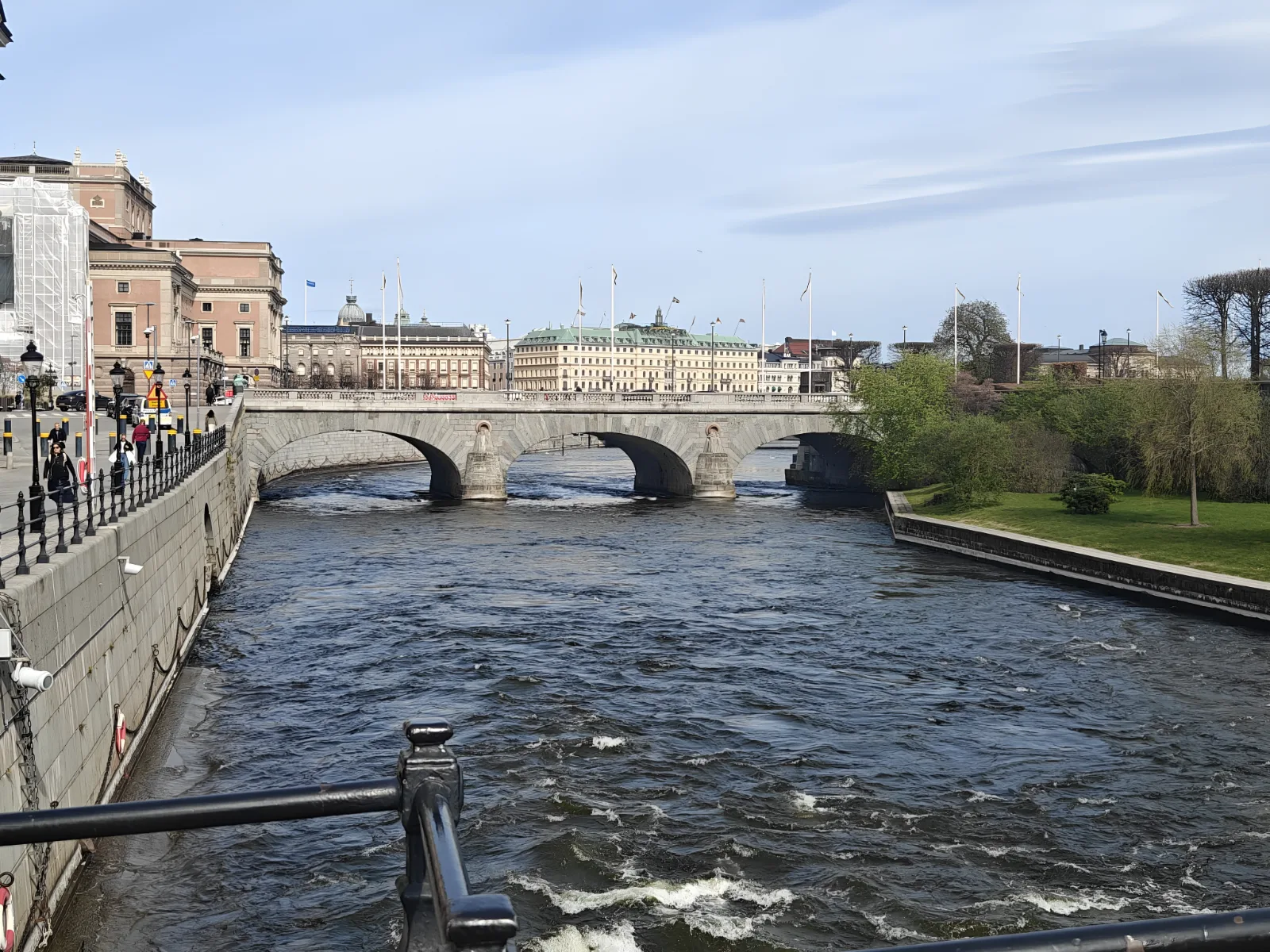A stone bridge over a river in Stockholm on a clear day